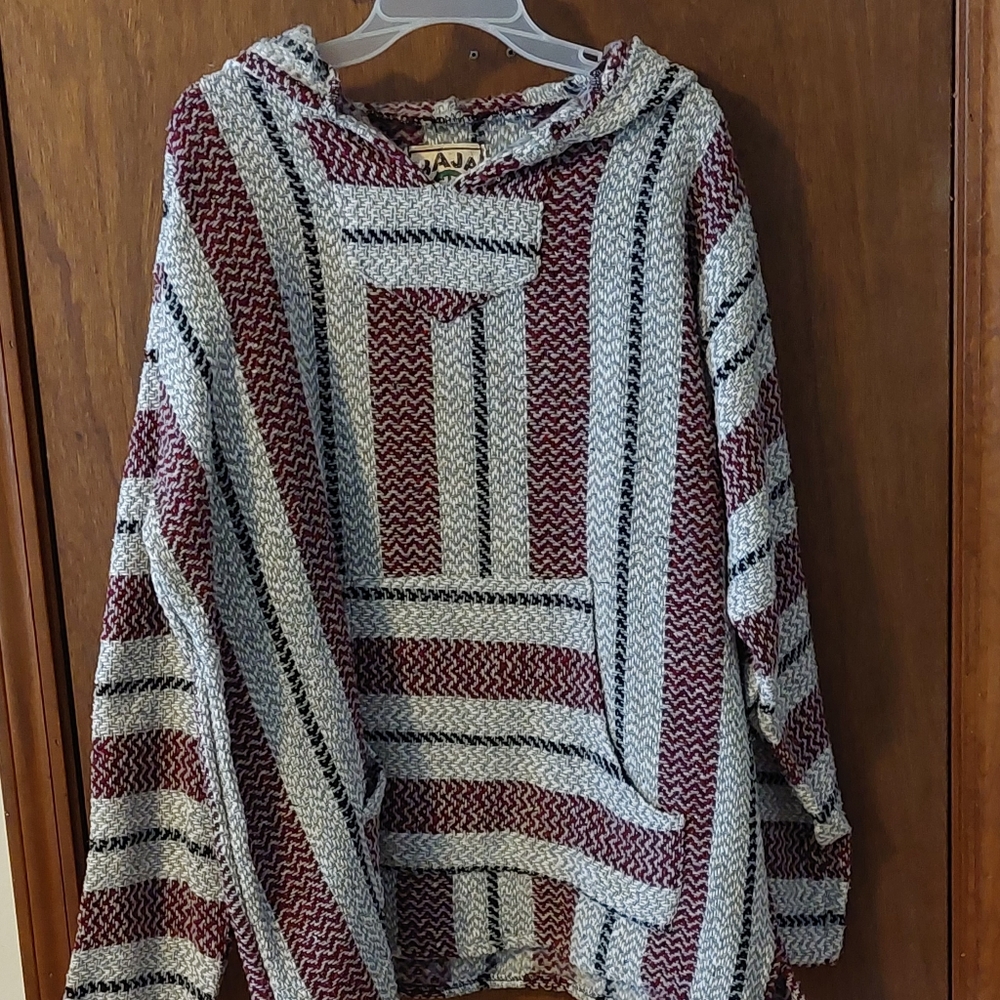 Pull over sweater with hood and pocket in the front.